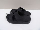 a pair of black sandals on a white surface