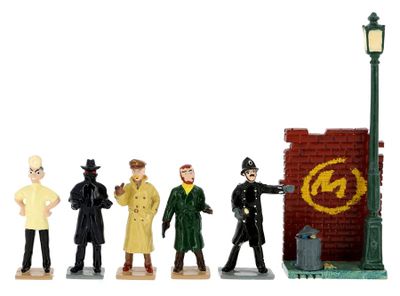 figurines of a group of people standing in front of a brick wall