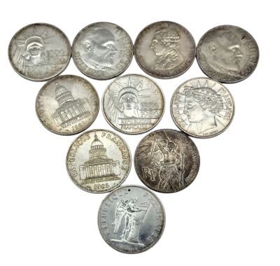 a lot of coins that are arranged in the shape of a heart