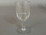 a wine glass sitting on a table with a white background