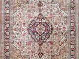 an antique persian rug with a medallion design on a pink background