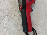 an infrared thermometer is laying on the floor next to a cord
