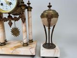 two clocks sitting next to each other on a table