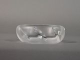 a clear glass bowl with two spoons inside of it