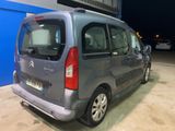 a small silver van parked in a parking lot