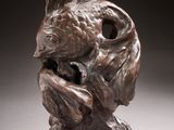 bronze sculpture of a dog ' s head on a white surface