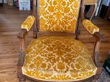a yellow chair that is sitting in a living room