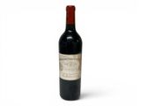 une bouteille de vin rouge posée sur une table blanche