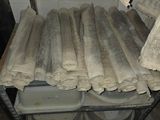 several rolls of toilet paper on a rack in a bathroom