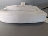 a white purse that is sitting on a table