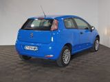a picture of a small blue car parked in a garage