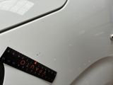 a sticker on the hood of a white car