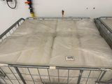 two mattresses in a metal cart in a room