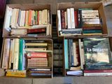 many books that are in a box on the floor