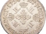 a close up of a silver coin with a crown on it