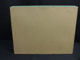 an empty cardboard box sitting on top of a black surface