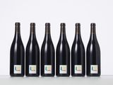 six bottles of wine lined up in a row on a table