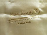 a close up of a white shirt with gold writing on it