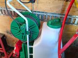 a picture of a green and white sprayer next to a red and white hose