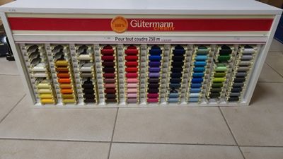 a display of different colored threads in a store
