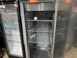 two refrigerators that are open in a kitchen