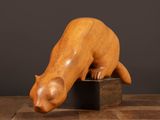 an image of a wooden sculpture of a cat on a block