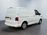 the back end of a white van parked in a large room