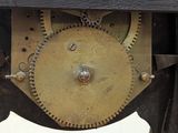 a close up of a clock with a flower on it