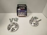 an image of a pair of wheel spacers and bolts on a white surface