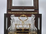 a glass set in a wooden box with a mirror