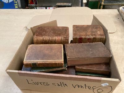 a box full of old books sitting on a table