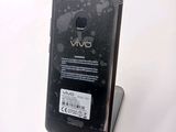 the back of a black cell phone sitting on top of a table