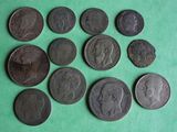 several different types of coins are arranged on a green surface