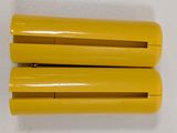 two pieces of yellow plastic are sitting on a white surface