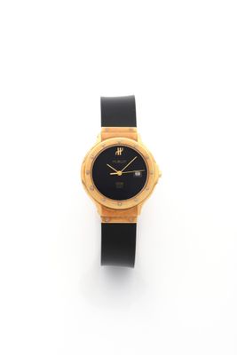 a close up of a wrist watch on a white surface