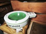 a green and white pot sitting on top of a wooden table
