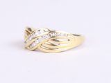 a close up of a gold ring with diamonds on a white background