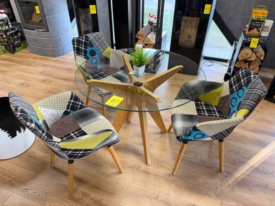 quatre chaises et une table dans une pièce avec du parquet