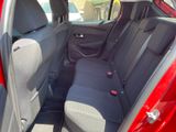 the back seats of a red car in a parking lot