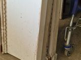 a white refrigerator sitting in the corner of a room