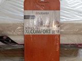 a surfboard that is sitting on top of a bed
