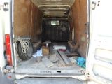a white van that has a lot of wood in the back