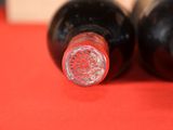 two bottles of wine that are sitting on a table