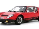the red sports car is parked on a white surface