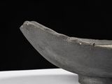 a black bowl that is sitting on a white table