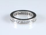 a close up of a diamond ring on a white surface