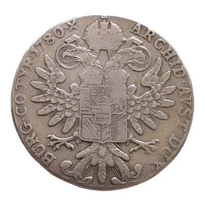 une vieille pièce d'argent sur laquelle figure un blason