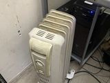 a radiator sitting next to a table with a laptop on it