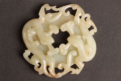 an image of a white jade pendant with a dragon design on it