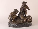bronze statue of a boy and two boys playing with a dog